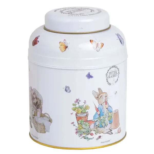 Decorative tin canister with illustrations of a rabbit and butterflies with English tea bags  inside.