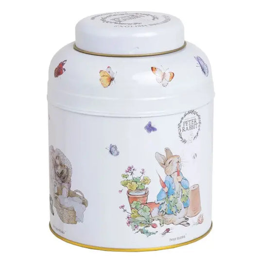 Decorative tin canister with illustrations of a rabbit and butterflies with English tea bags  inside.