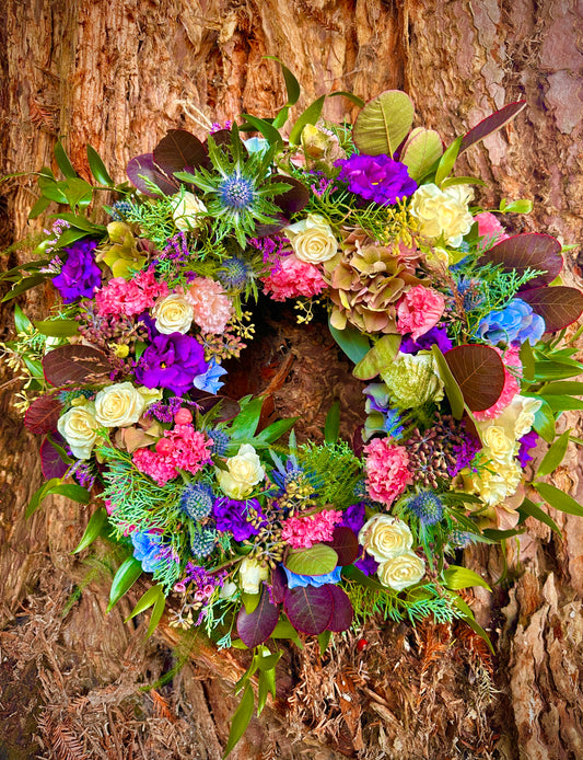 Pretty floral wreath in pinks, purples, blue and white