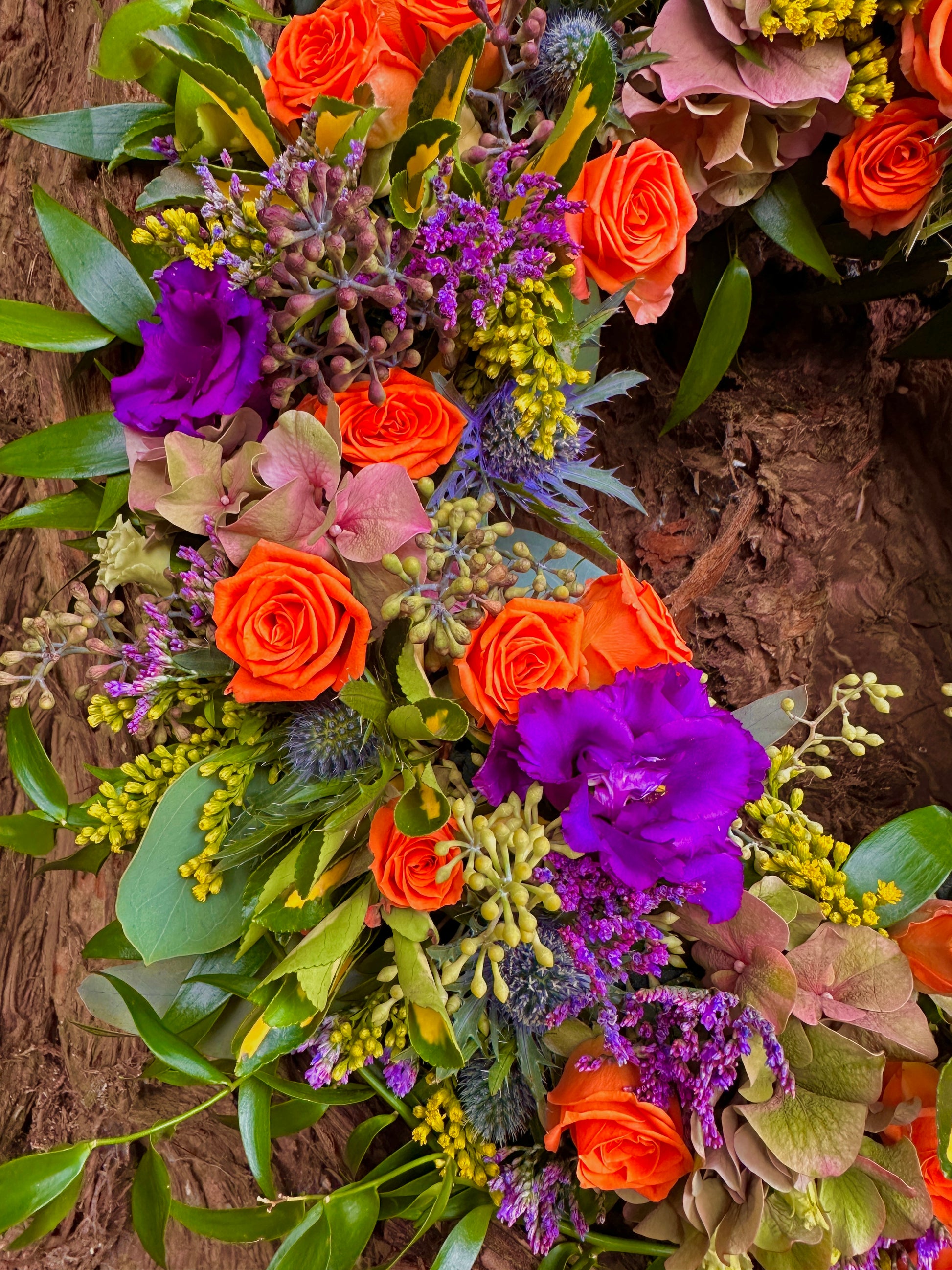  flowers in the colours of purple, orange and yellow