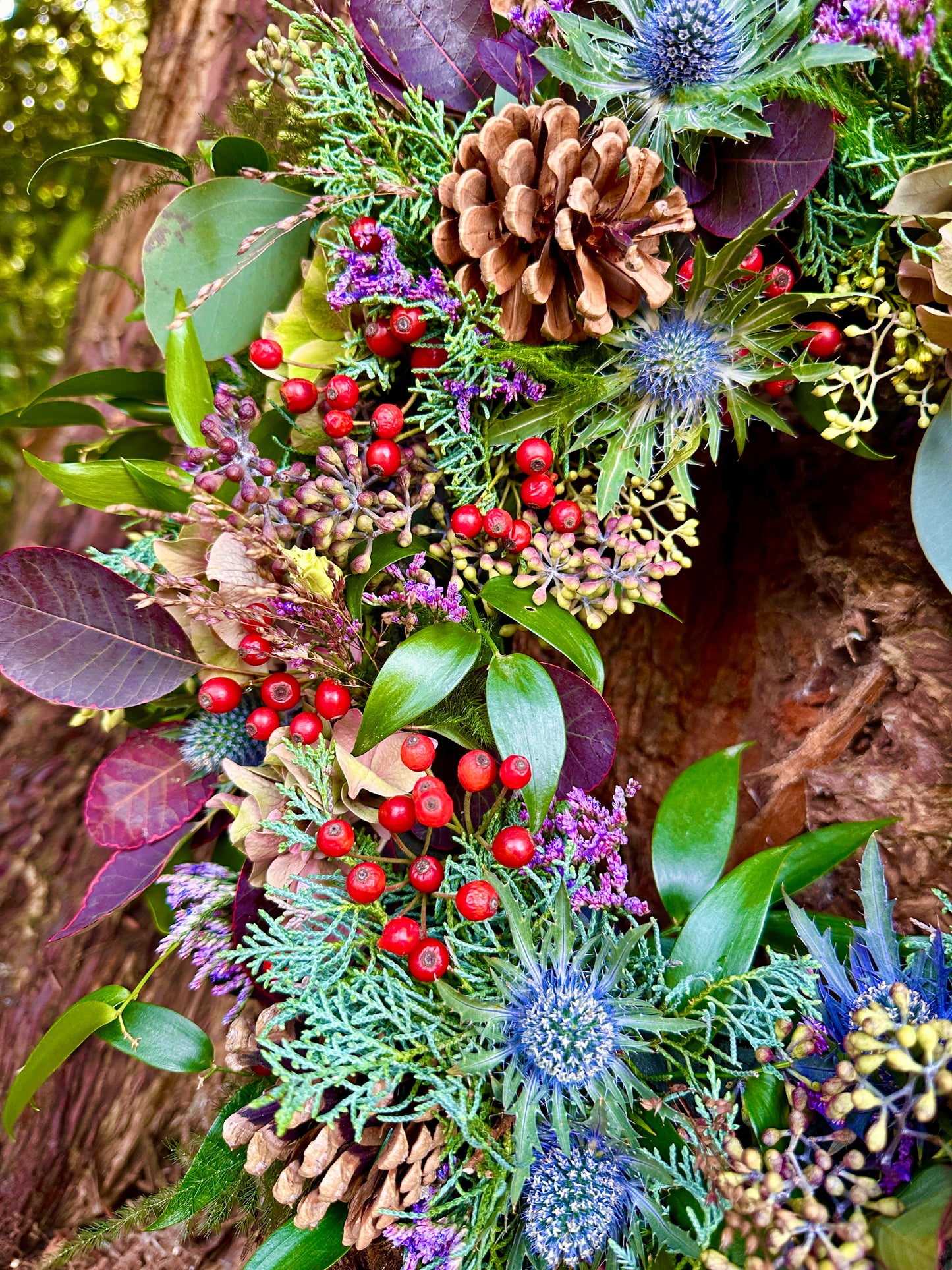 Decorative wreath with pinecones, berries, and greenery 